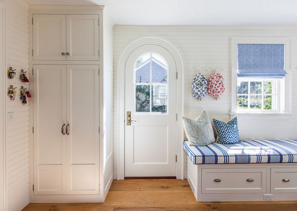     Mediterranean-style mudroom with coastal decor. What a sweet and functional mud room! The beautiful decor on the coast complements the classic architectural details. 