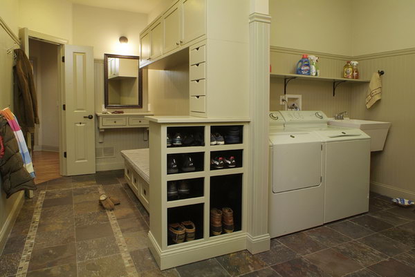     Gray mud room. This beautiful mud room offers space to keep the mud away. With easy-to-clean floors, lots of shoe storage under the bench, lots of hooks and even some spacious closets, this dirt room is really functional.