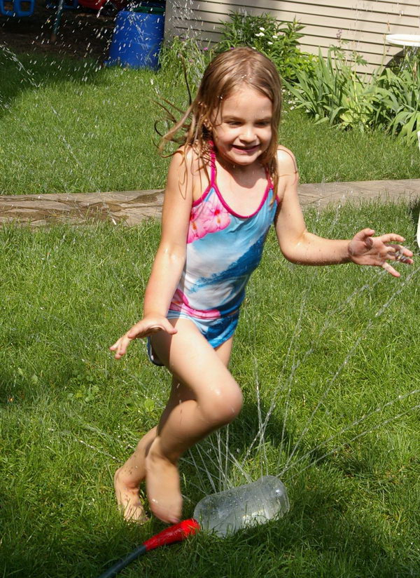     Water fun sprinkler. Simply attach the recycled large bottle with the drilled holes to the garden hose, and then the kids can have fun running and jumping in the summer. 