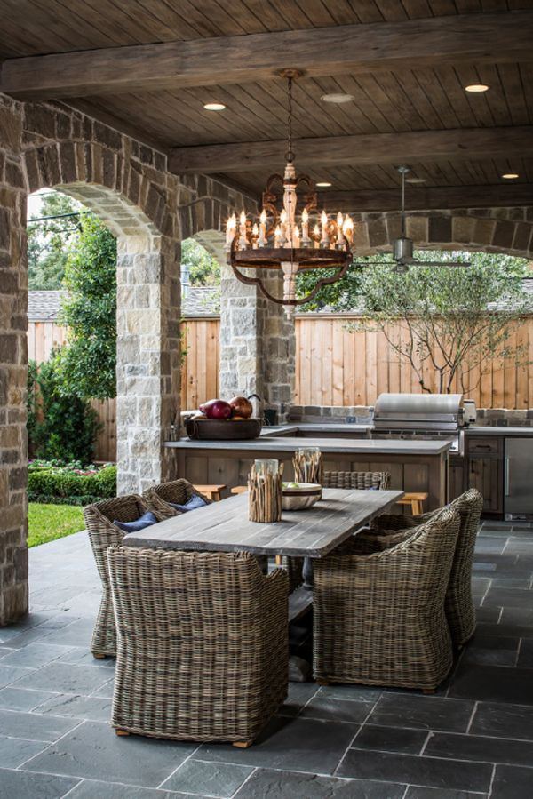 The chandelier gives this outdoor kitchen a secret and romance. The soft, warm light illuminates the room and gives these spring spots an irresistible charm. It really matches the foundation of stones and gray bricks. 