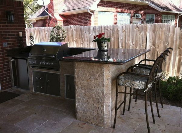 All materials in this outdoor kitchen are extremely durable, which is practically maintenance-free. An elegant outdoor kitchen connects to the house. 