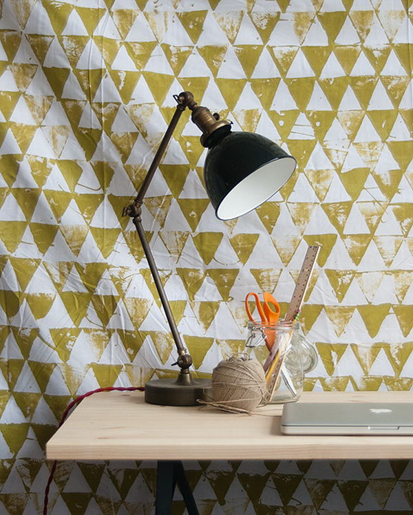 Geometric wall hanging. Place a plastic sheet under the sheet and dip the surface of the triangle in the paint to print the patterns on your color. It's great to redesign your space in this fashionable way.