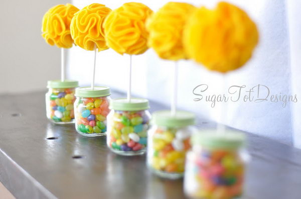     Baby food jar topiary. Fill the baby food jar with colorful gummy bears and insert it with a puffy flower topiary for an exquisite view. These adorable things would be great centerpieces for a baby shower.