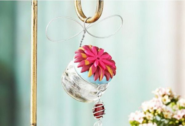Hummingbird feeder. Paint the lid of the jar, glue plastic flowers on top for a nice decor. Hang it around the hook. Replace your outdated hummingbird feeder with this exquisite one for practical use as well as for a beautiful decor.