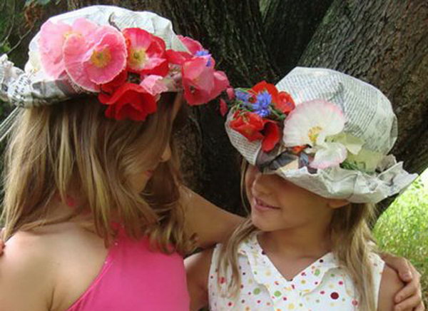 Flower hat. Put newspaper sheets over your head and shape them. Glue the head around, add flowers and glue it in place. Roll the brim on your forehead to round off this gorgeous flower hat.