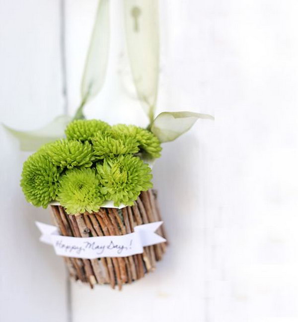 May baskets. Snap the branches to the size of your yogurt container, stick the message banner over the sticks, add the ribbon and flowers, and hang it up to create a sweet and fresh natural decor that will surprise all your friends and family members.