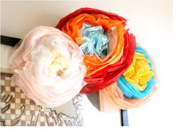 DIY festive paper flower. Fold the stack of tissue paper into 3 colors. Staple the middle section to secure it. Scrunch it into circular curves to form the petal shape. It is super chic to arrange them as a beautiful bouquet for decoration in May to impress all your friends and relatives.