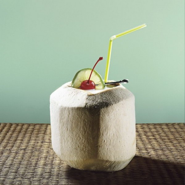 Luau coconut. Serve guests fun and enjoy your summer party for a fantastic taste. Cut the top of the coconut, add ice and shaker contents, garnish with lime slice and maraschino cherry. Serve with a straw and spoon to scrape the coconut out of the shell and taste the breathtaking taste.