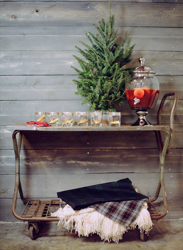 Rolling beverage cart. Make this rolling beverage cart with mini tree, mulled wine cocktail decanter and throw blankets down in creamy and cozy checkered tartan. This trolley beverage station is really amazing for its mobile style.