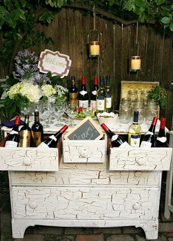 Wine-themed beverage station. This wine beverage station is perfect for your wedding reception with bottles, a cheer sign and the well-presented glasses. With this creative beverage station you can integrate your personalities and passions into your reception decor.
