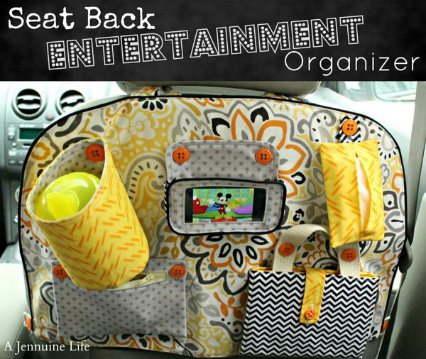Seat backrest entertainment organizer. This beautiful and cool organizer for seat back entertainment is handmade with a cup holder, a phone holster, a handkerchief bag, a zipper bag and a coloring sheet. It is easy to make one for a good user of the sewing machine. 