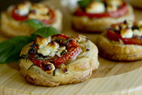 Tomato and goat cheese tarts. Treat your guests to this perfect hearty starter or side dish. You have to enjoy the sweet taste of tomatoes and the goat cheese goes perfectly with the pastries.