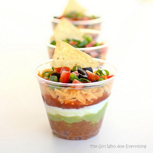 Individual seven-layer dips. You may be wondering how you can create these colorful seven layers. This starter combines bean and taco spices, sour cream, guacamole, salsa or pico de gallo, cheese, tomatoes and spring onions. It is perfect for a normal party or meeting. 
