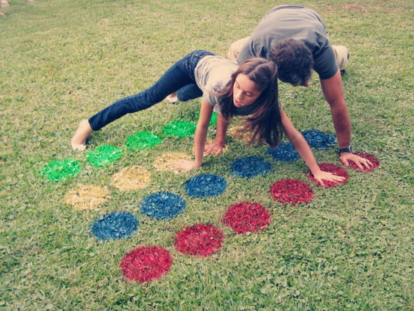 Outdoor twister graduation idea. This game is the perfect addition to your graduation party for the outdoor gathering as only 4 cans of colorful spray paint and 5 sheets of poster paper are used.