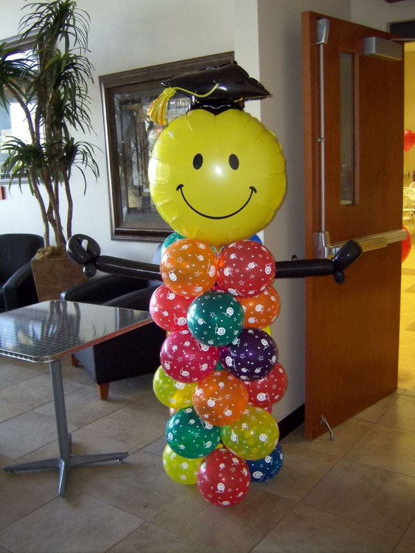 Graduation balloon decor. This balloon graduate is really breathtaking and eye-catching. All you need is to put together colorful balloons in different shapes.