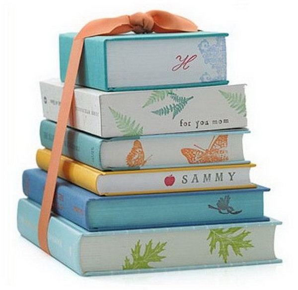 Graduation ceremony centerpiece. Design the stacked books with cool, modern gift wrapping in colorful prints to match your graduation theme. You can even decorate the pages with the names of the guests of honor.
