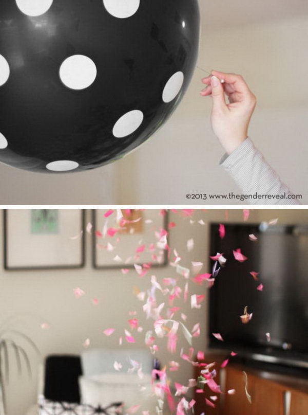 Balloon confetti gender reveal party. Hang up black polka dot balloons to make the great discovery with colorful confetti inside. Discover the gender based on the color of the confetti by bursting the balloons.