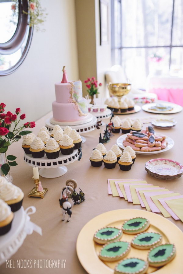 Malicious princess aurora party idea. I really adore this party design with a combination of sweet cake, hanging crest, adorned with flower garlands, malicious cookies, floral crown and spool of thread to create a whimsically soft style and floral design taste.