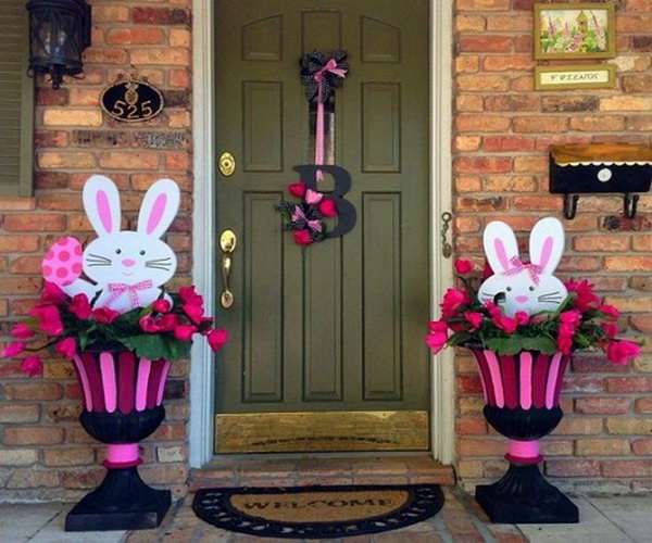 Easter bunny decoration. The cute Easter bunny in the decorated flower bed makes this decoration style lively and fun. The left one holds the Easter egg while the other tries to hide in the flower bed.
