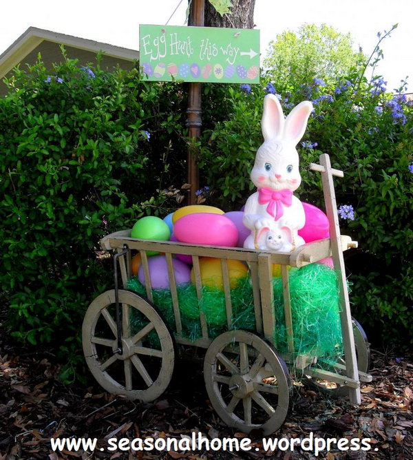 Easter yard decoration. Display a cart with colorful Easter eggs and put a cute Easter bunny on top. You can also hang up the guide board to show the way for the egg hunt.
