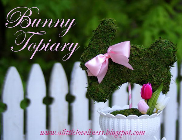 Make a bunny topiary. Take a white bowl and cover it with a circle of moss. Add some pink Easter eggs and silk tulip. Place a moss-covered rabbit on the strip. Decorate the rabbit with a pink ribbon around your neck.