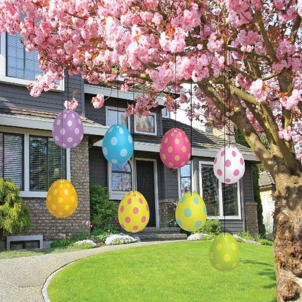 Easter egg decoration. Hang colorful Easter eggs under the branches of a beautiful flower tree. This is a simple yet fantastic way to decorate your garden for Easter. These plastic Easter eggs with polka dots are weatherproof and durable.