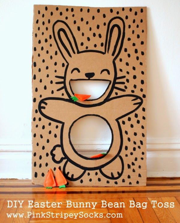 Throw DIY Easter bunny beanbag. Set up a simple cardboard Easter bunny beanbag throwing game with carrot beanbags. Children will have fun playing this at a party.