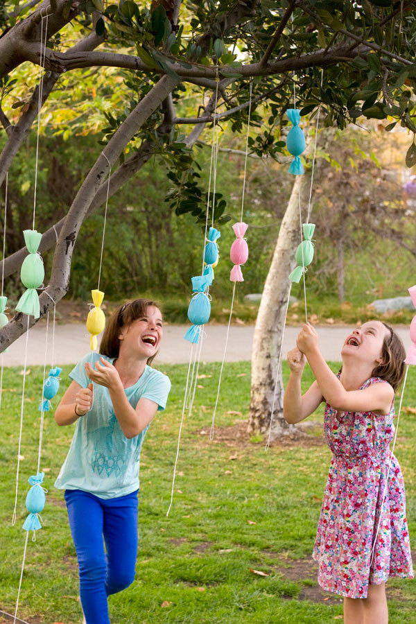 DIY Egg Popper Tree. Wrap the candy-filled poppers like small egg-shaped candy. Hang them on a tree and let the kids go and pop while they collect sweets. This is a cool and fun idea for Easter egg hunt.