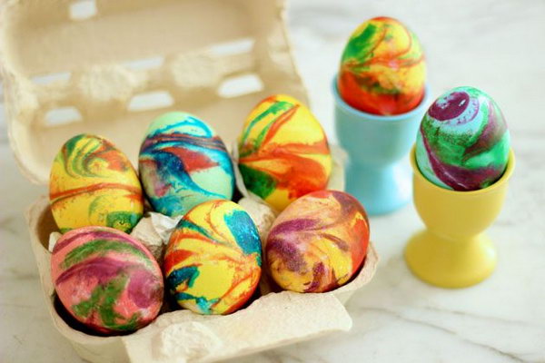 Swirling Easter eggs make a nice display. You can do this in just 3 simple steps: coloring the base color, getting swirls through shaving cream and rolling eggs.
