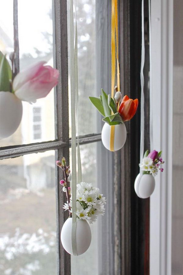 DIY hanging Easter eggs. Beautiful Easter sunlight shines through your window on Easter morning. Create this cool installation of a light egg vase with flowers on your window.