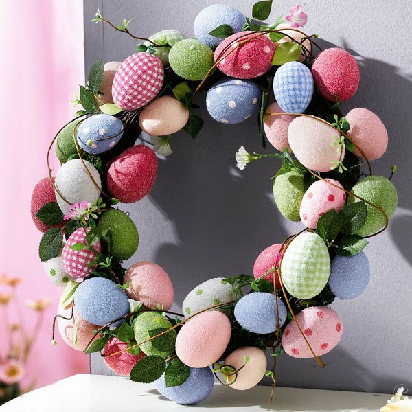 Use bright Easter eggs with polka dots and leaves to decorate them into an Easter egg wreath.
