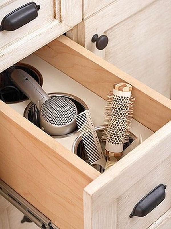 Bathroom drawer for with compartments. Place a piece of wood and several containers in your bathroom drawer. Create additional space and organize your hair dryer.  