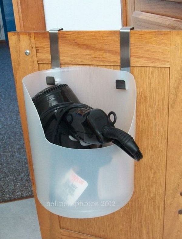 Plastic bottle holder. Recycle a used bleach bottle as a portable and inexpensive hair dryer caddy. Install it over the bottom cabinet door. Take the dryer and chunky cord off your bathroom counter. 
