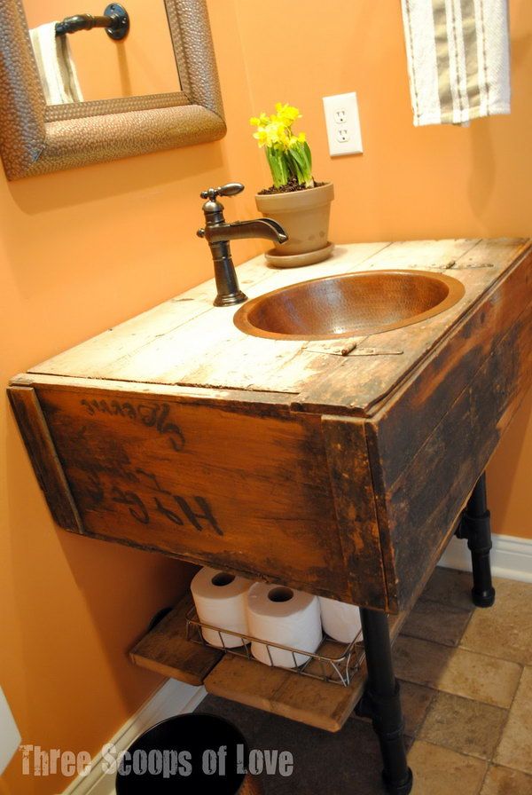 Toilet paper storage under the sink. Place a wooden board under the vanity to store the toilet paper rolls. The vanity from a safe closet and the board under the sink give your bathroom a vintage touch. 