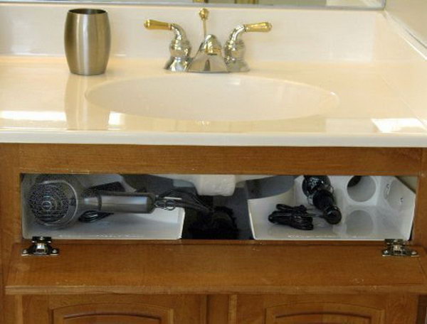 Curling iron holder under sink. Install the storage unit behind the wrong front of your bathroom cabinet around the bottom of your sink. Free up wasted space in your cupboards and drawers and clear away your worktops. 
