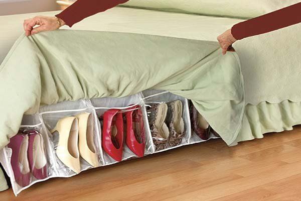 Bed skirt shoe organizer. Free up valuable space in your bedroom with this innovative bed skirt organizer. It is a very clever shoe storage idea for small bedrooms. The bed skirt completely covers the shoe organizer and makes it well hidden, but is still easily accessible.