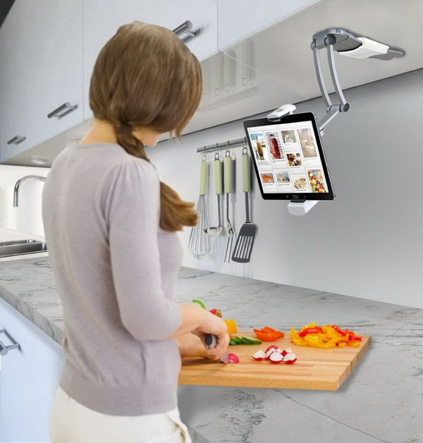 Kitchen holder for iPad. This tablet stand is mounted on the bottom of a kitchen cabinet and is perfect when you need recipes. 