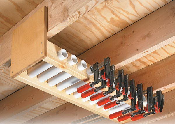 Garage overhead clamp rack. Short PVC pipe lengths in the rack serve as compartments in which each clamp is stored individually. By aligning the tubes side by side, you can easily access the exact size of the clamp needed. 