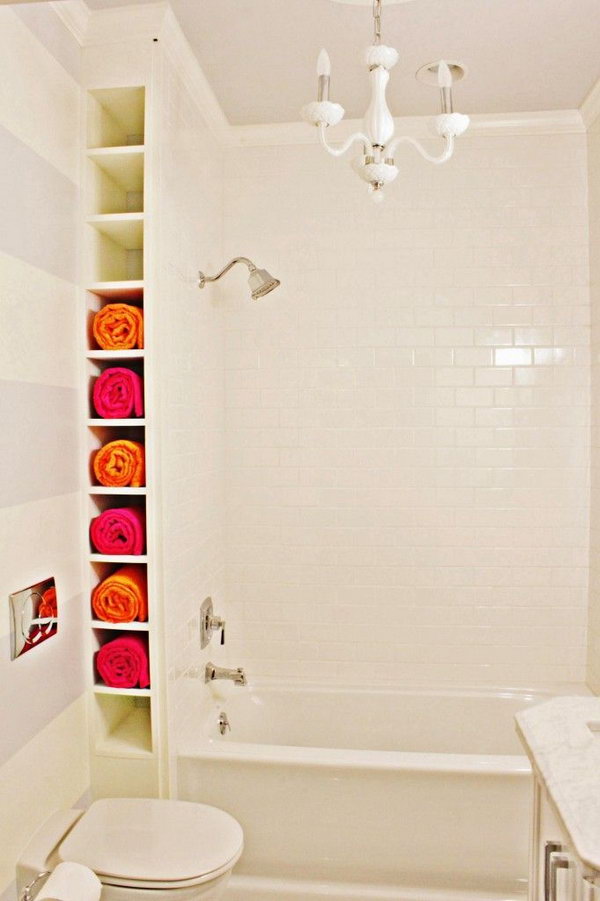 A corner by the tub. Create a ceiling-high frame between the wall and the tub. The room may be small, but they are perfect for storing rolled towels. 