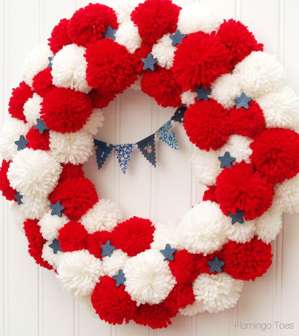 Patriotic pom pom wreath for July 4th or memorial day. The pom pommyness of this wreath is so cute. A great idea for all summer vacation. 
