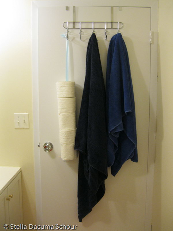 Hang your toilet paper rolls behind the bathroom door for extra space and out of sight. 