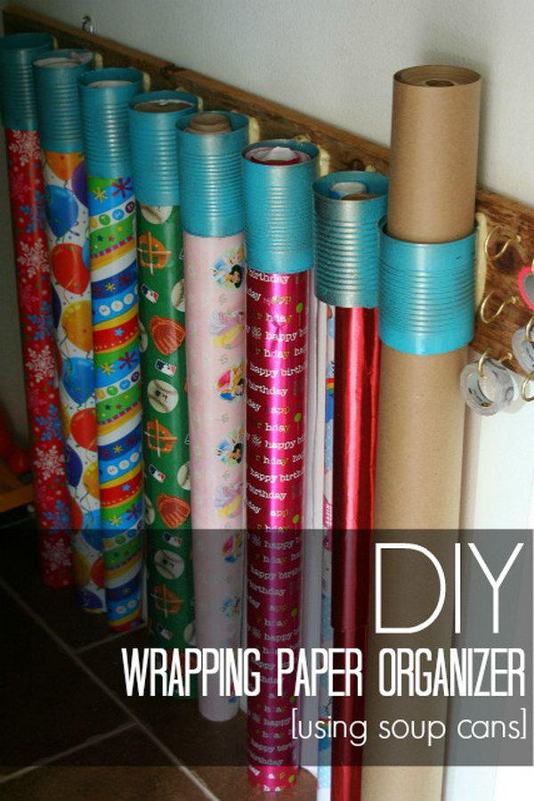 DIY gift wrap organizer made from soup cans and old wood. 