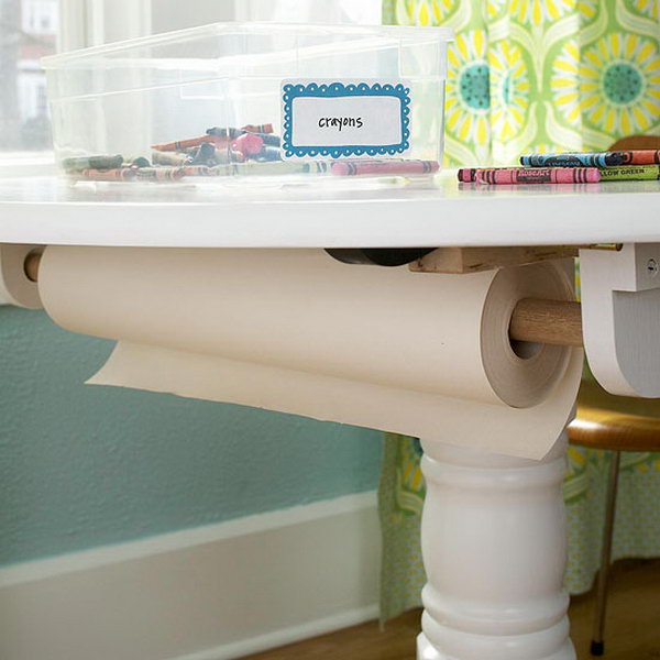 Screw a holder to the bottom of the table to store a spool of wrapping paper. 