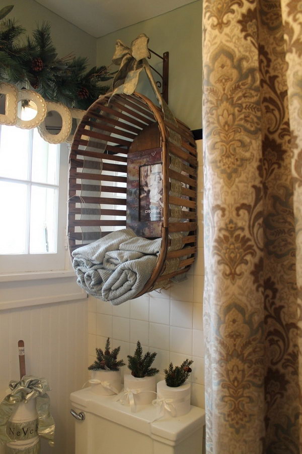 Upcycling an old wooden basket into a towel rack above the toilet. 