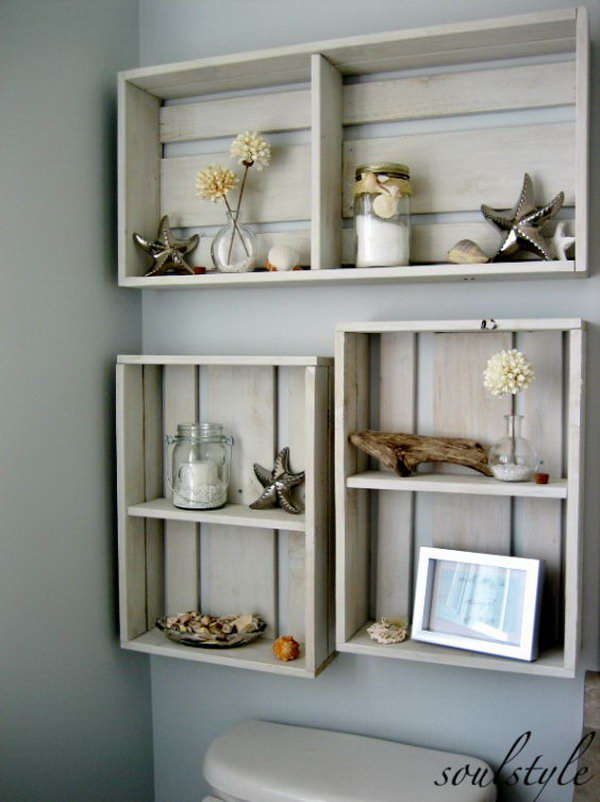 Hang some DIY boxes on the area above the toilet to add some decor. The dried beach dahlias in tiny bubble vases, mason jars with candles and bath salts, some driftwood and a few starfish and shells make your bathroom super fantastic. 