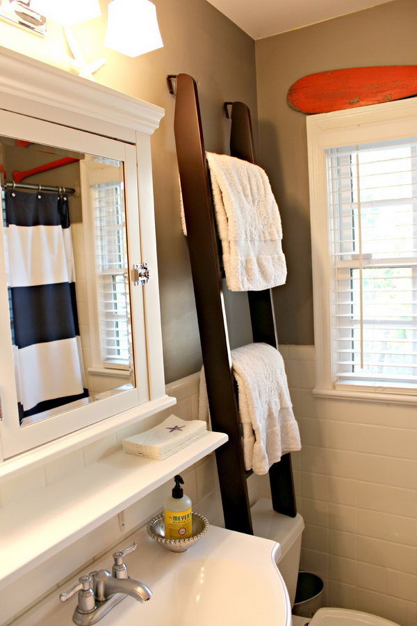 This ladder towel holder over the toilet was used for storing towels and for visual height in the small space. 