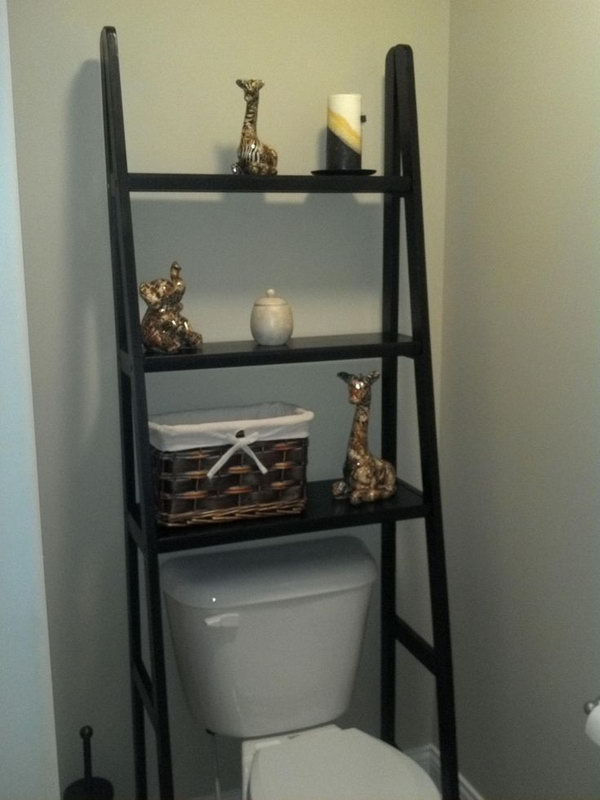 Take a ladder shelf and leave out the bottom 2 rows so they fit perfectly over the toilet. This could create additional storage space without looking too bulky. 