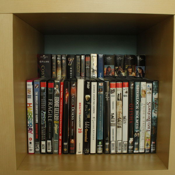 Double the DVD storage space by placing a raised shelf on the back of a bookshelf. 