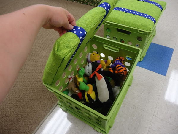 What a clever idea for storing toys with recycled milk crates. Cut a piece of wood so that it fits on the inside lip of the box. Use cushions from the Walmart craft department to cushion the seat and tack fabric. 