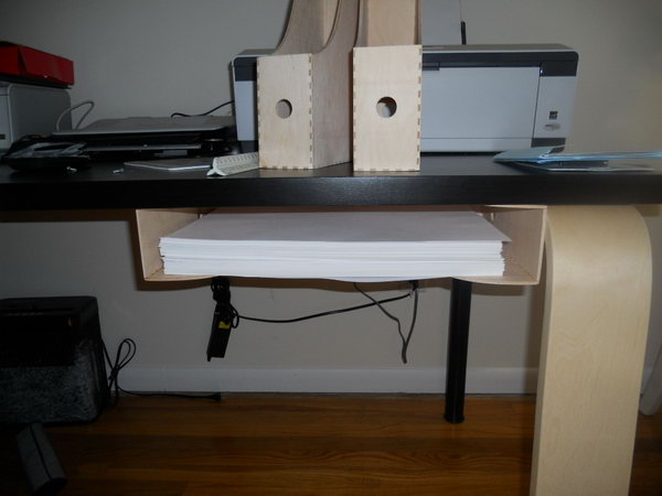 I have a cool idea to keep this printer paper under the table with the magazine holder.  